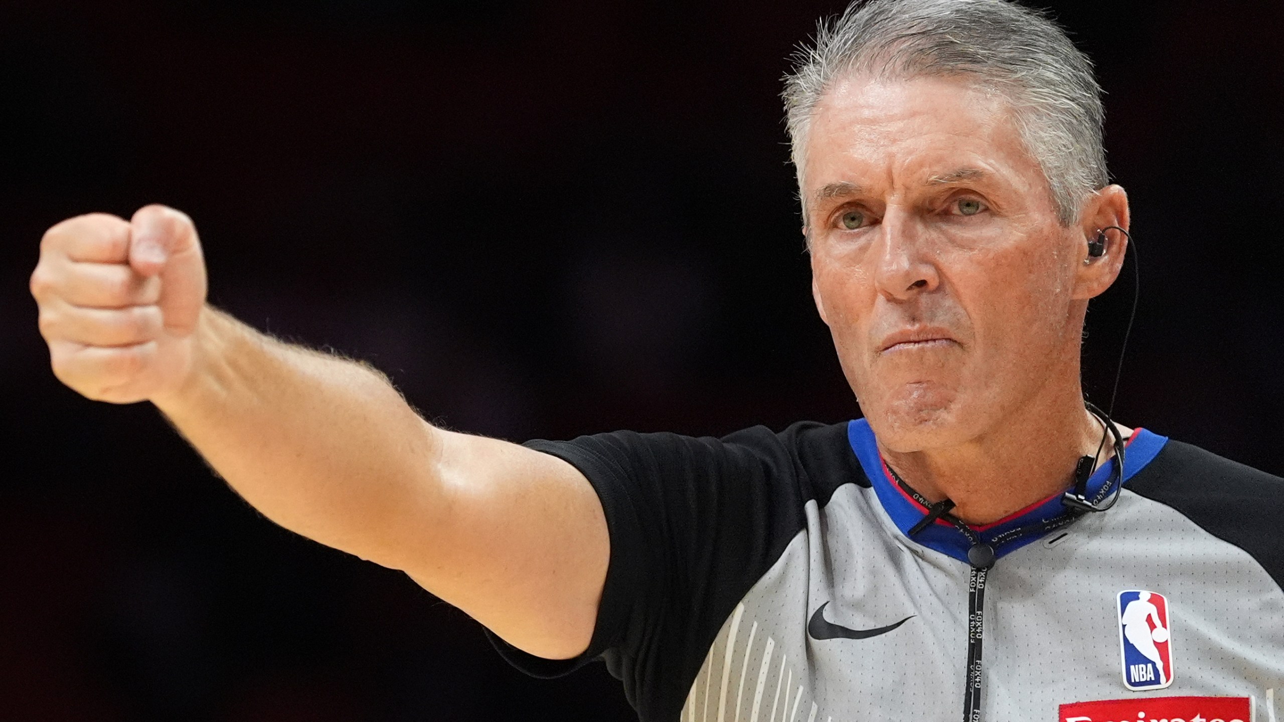 Referee Scott Foster, wearing an earpiece, signals a call during the second half of a preseason NBA basketball game between the Miami Heat and the Milwaukee Bucks, Monday, Oct. 6, 2025, in Miami. (AP Photo/Rebecca Blackwell)