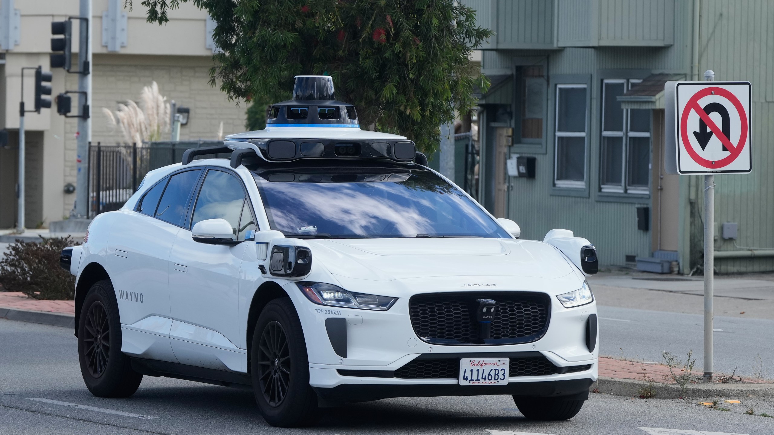 A Waymo vehicle drives past a No U-Turn sign in San Bruno, Calif., Tuesday, Sept. 30, 2025. (AP Photo/Jeff Chiu)