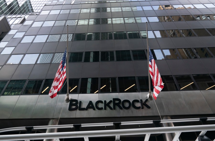 FILE -Flags fly on the front of BlackRock headquarters, Wednesday, Jan. 13, 2021, in New York. . (AP Photo/Mark Lennihan, File)