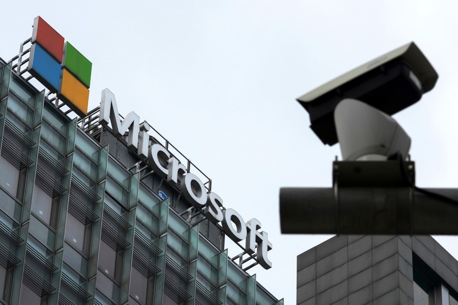 FILE - A security surveillance camera is seen near the Microsoft office building in Beijing, July 20, 2021. (AP Photo/Andy Wong, File)