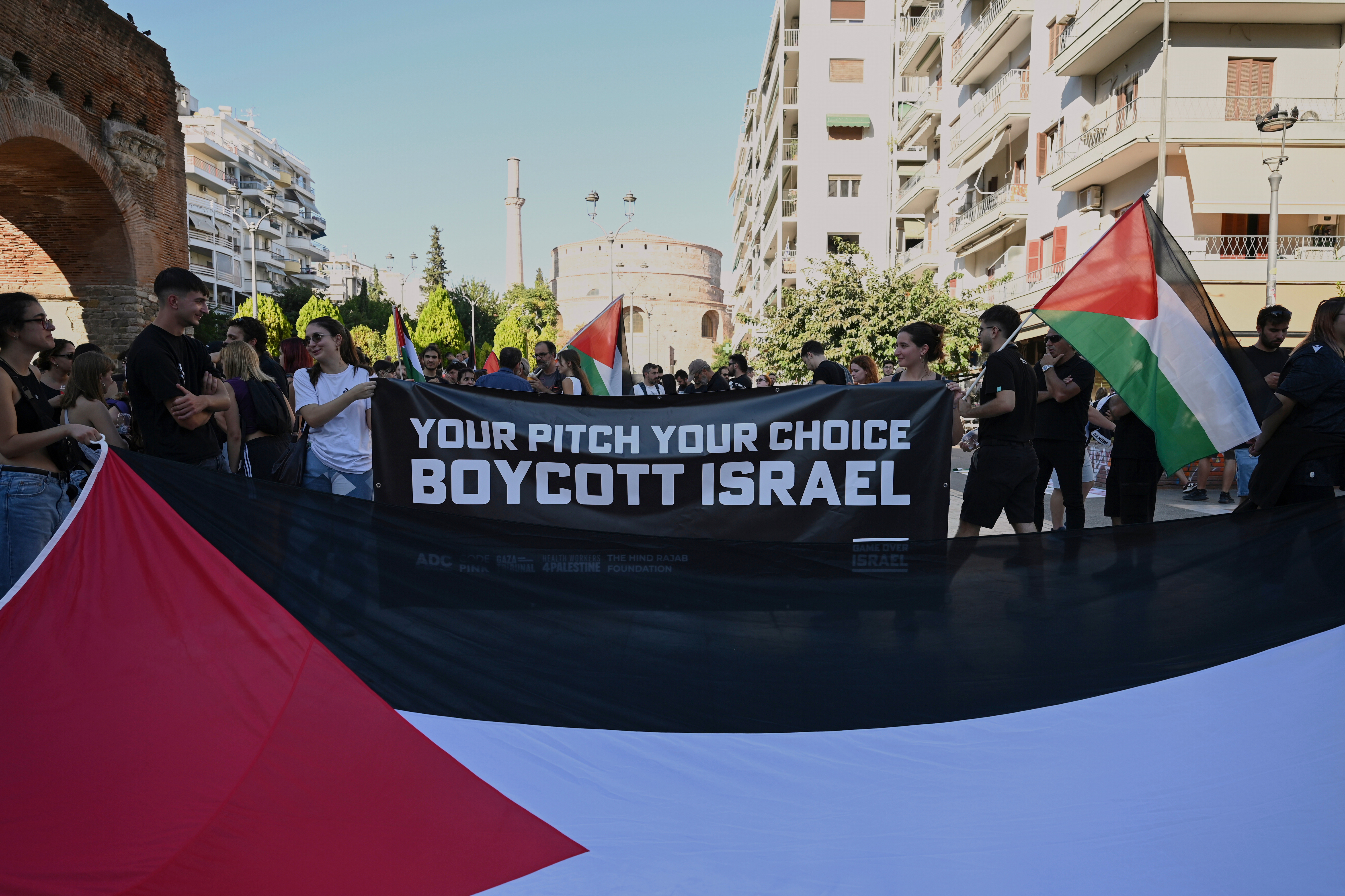 Pro-Palestinian protesters, most of them PAOK fans, gather ahead of a Europa League soccer match between PAOK and Israeli team Maccabi Tel Aviv in the port city of Thessaloniki, northern Greece, Wednesday, Sept. 24, 2025. (AP Photo/Giannis Papanikos)