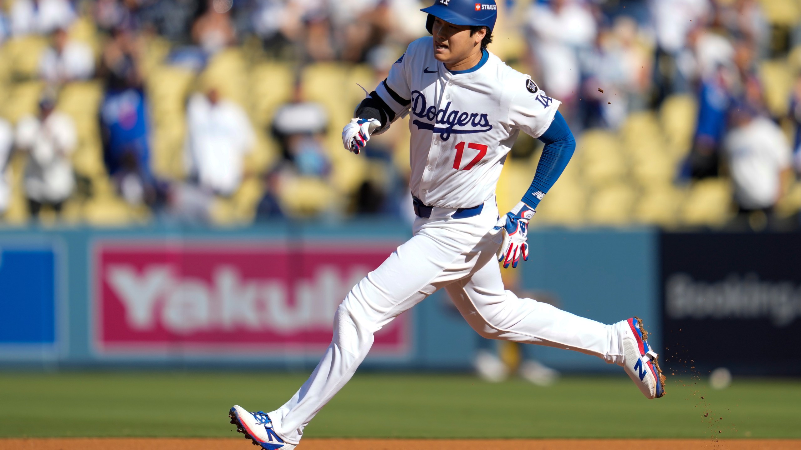 Los Angeles Dodgers' Shohei Ohtani rounds the bases after a triple against the Milwaukee Brewers during the first inning in Game 3 of baseball's National League Championship Series, Thursday, Oct. 16, 2025, in Los Angeles. (AP Photo/Ashley Landis)