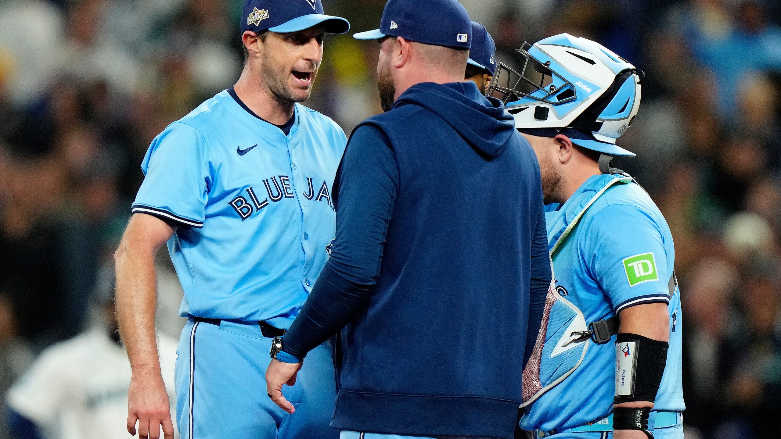 Toronto Blue Jays pitcher Max Scherzer (31) shares some words with Toronto Blue Jays manager John Schneider during a visit to the mound in fifth inning MLB American League Championship Series game 4 baseball action against the Seattle Mariners, in Seattle, Thursday, Oct. 16, 2025. (Frank Gunn/The Canadian Press via AP)