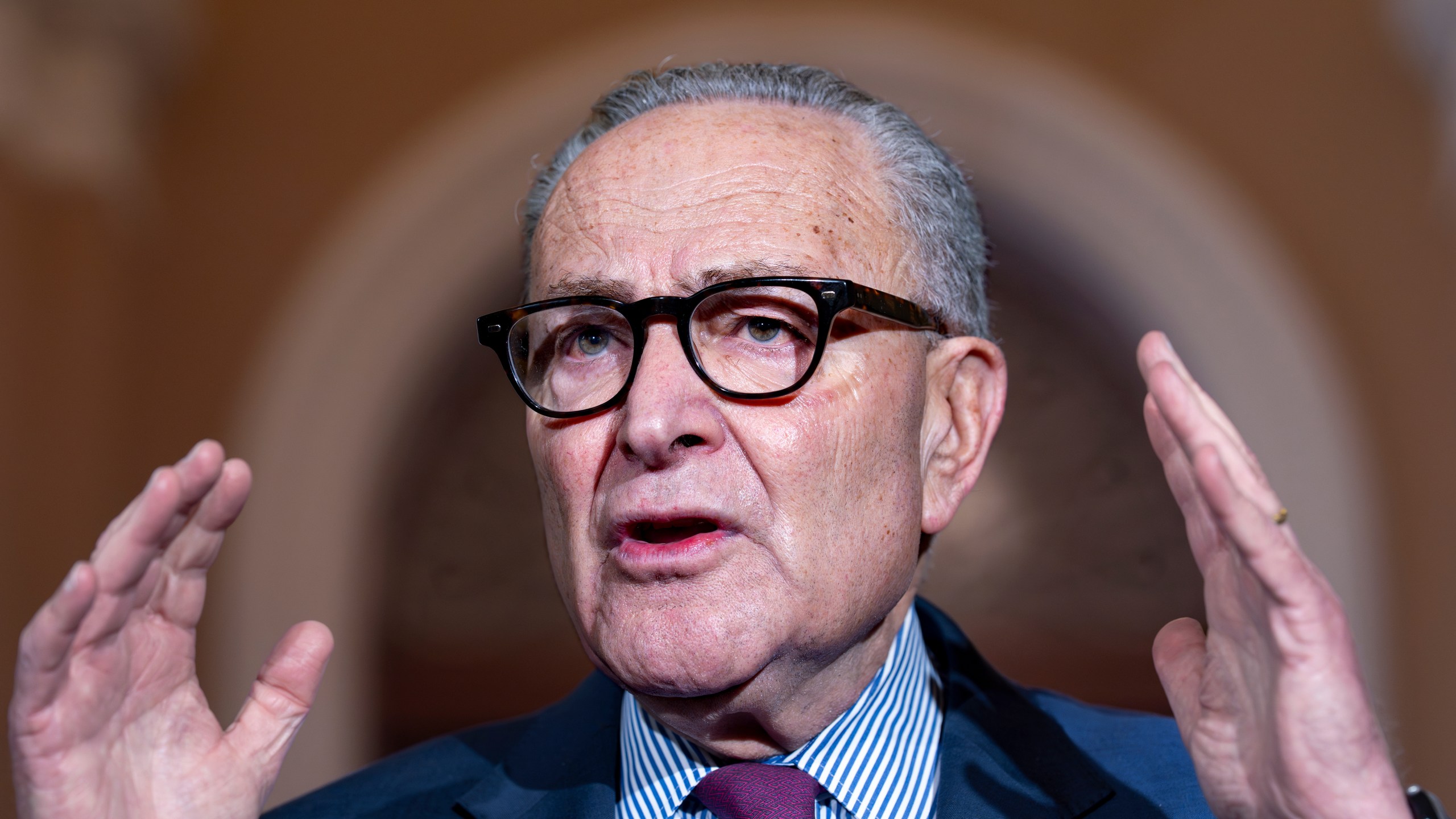 Senate Minority Leader Chuck Schumer, D-N.Y., expresses his frustration as he speaks to reporters outside the Senate chamber to blame President Donald Trump and the Republicans with the government shutdown, at the Capitol in Washington, Thursday, Oct. 16, 2025. (AP Photo/J. Scott Applewhite)