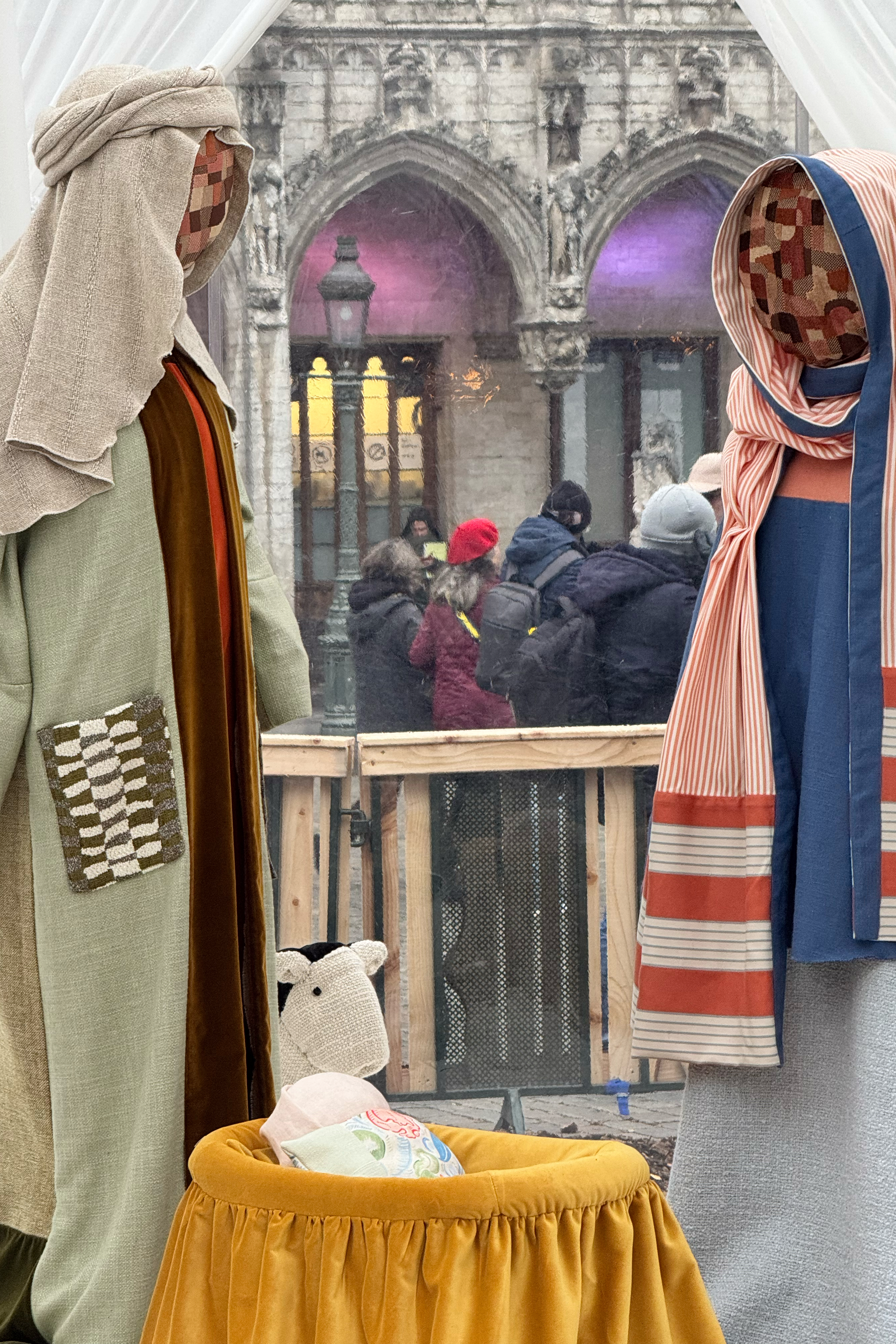 A Nativity scene containing characters with cloth faces, by Belgian artist Victoria-Maria Geyer, is displayed in a white tent in Brussels, Monday, Dec. 1, 2025. (AP Photo/Sylvain Plazy)
