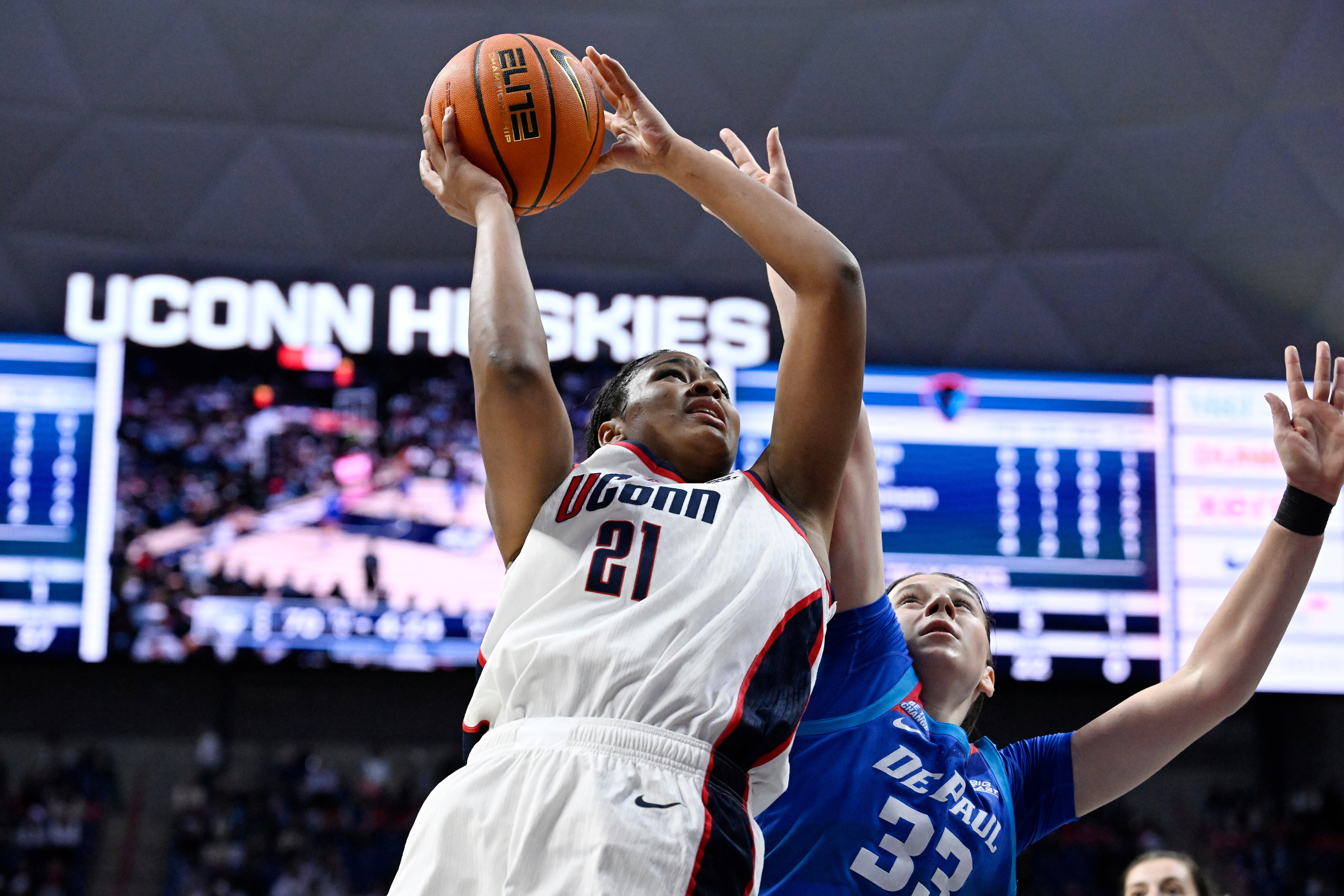 UConn forward Sarah Strong (21) looks to shoot as DePaul guard Kate Novik (33) defends in the second half of an NCAA college basketball game, Sunday, Dec. 7, 2025, in Storrs, Conn. (AP Photo/Jessica Hill)