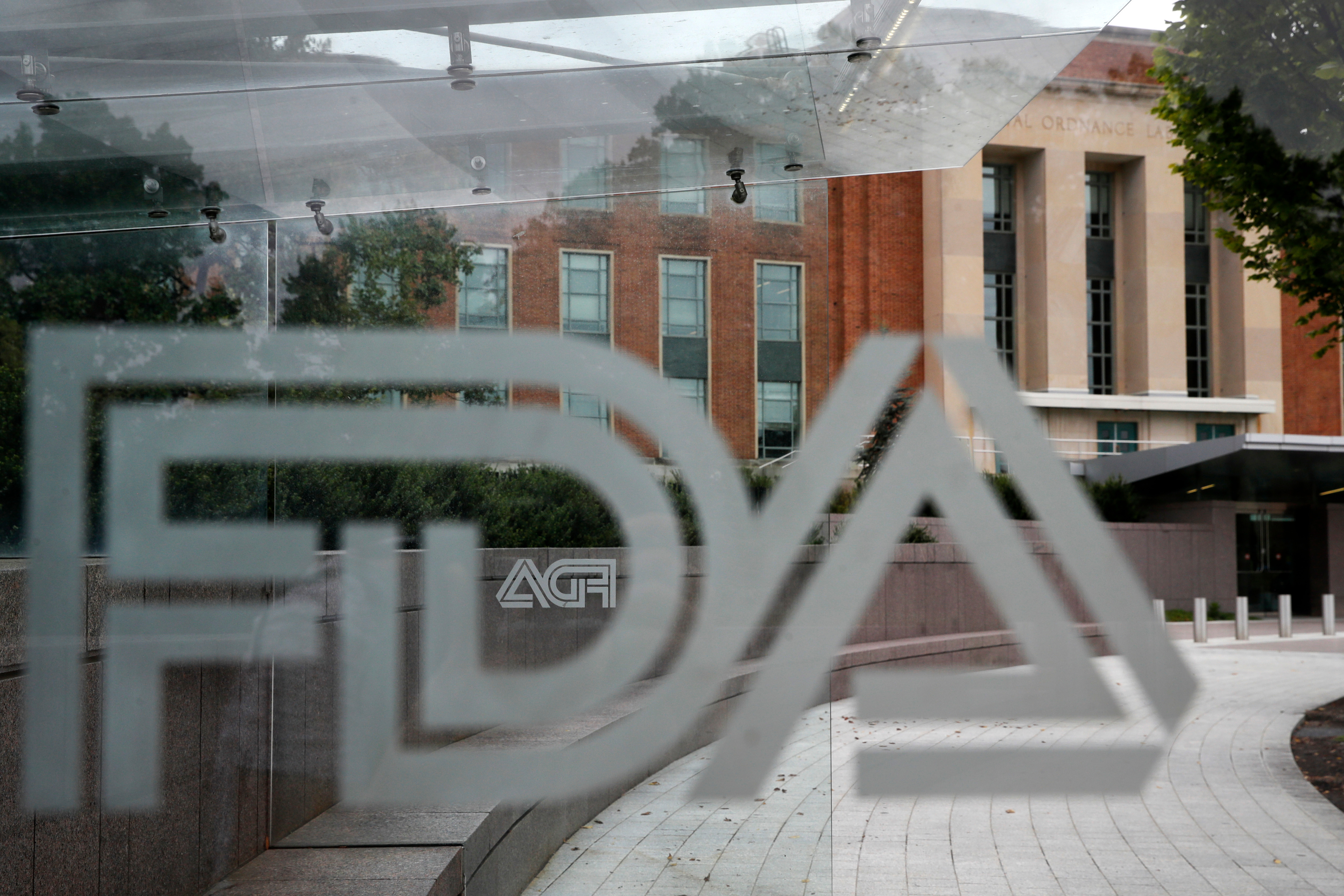 FILE - The U.S. Food and Drug Administration building is seen behind FDA logos at a bus stop on the agency's campus in Silver Spring, Md., Aug. 2, 2018. (AP Photo/Jacquelyn Martin, File)