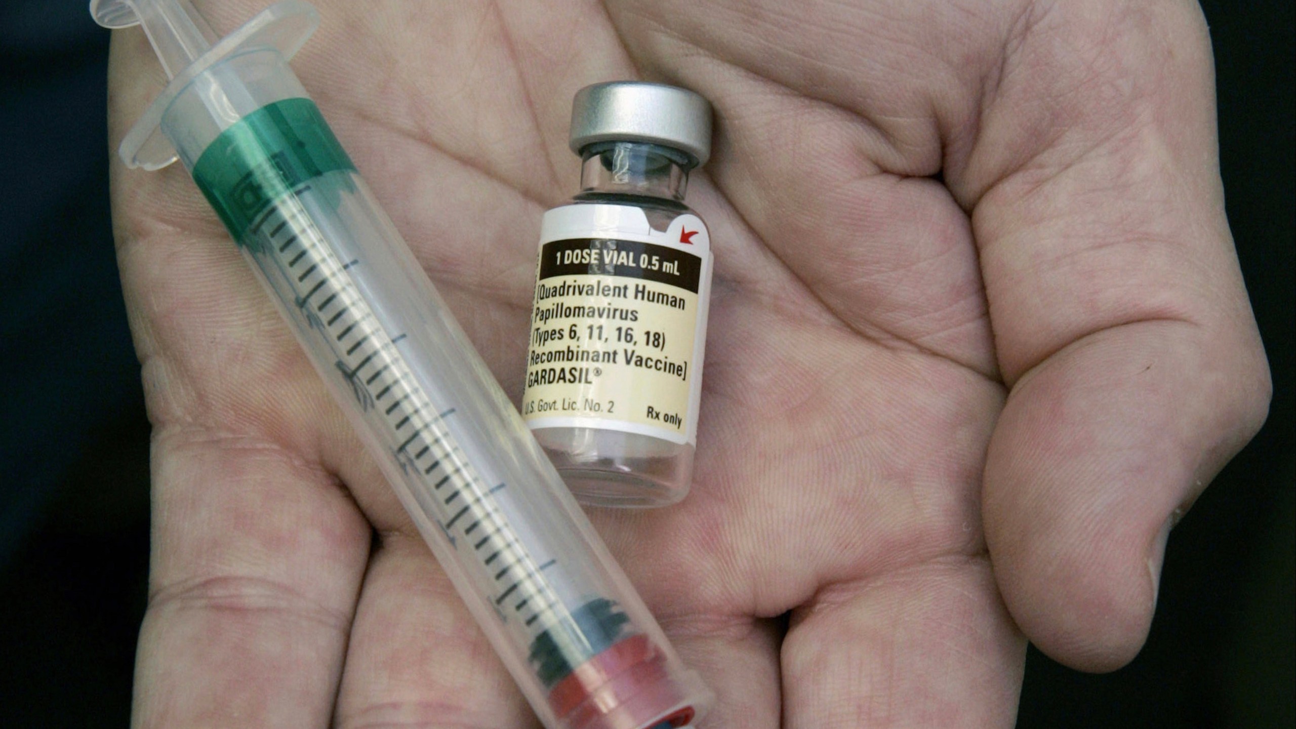 FILE - A doctor holds a vial of the human papillomavirus (HPV) vaccine Gardasil in Chicago on Aug. 28, 2006. (AP Photo/Charles Rex Arbogast, File)