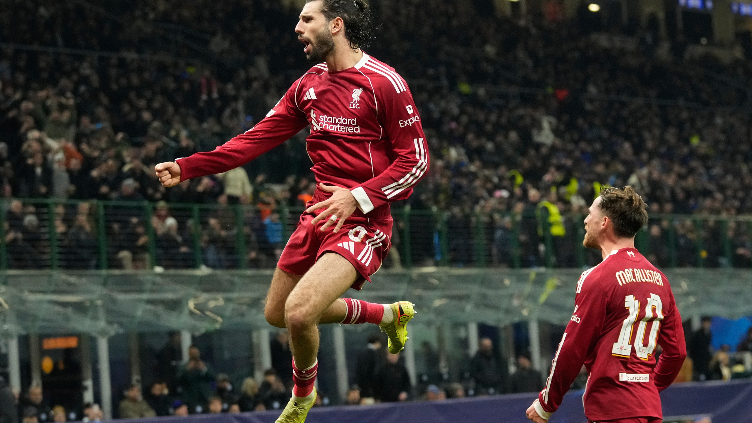 Liverpool's Dominik Szoboszlai celebrates after scoring his side's first goal from a penalty shot during a Champions League, league phase, soccer match between Inter Milan and Liverpool in Milan, Italy, Tuesday, Dec.9, 2025. (AP Photo/Luca Bruno)