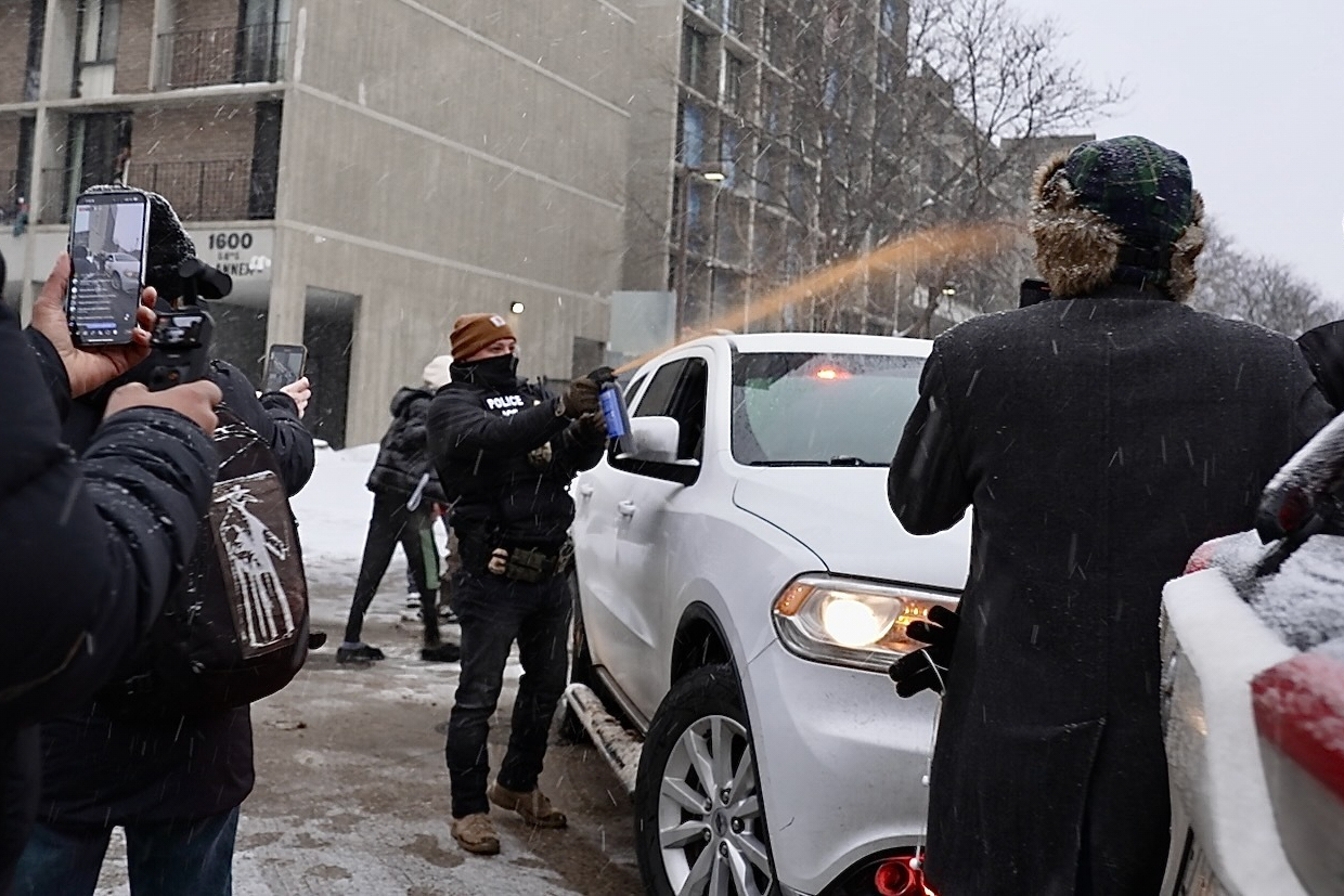 Activists confronted a group of Immigration and Customs Enforcement officers in the largely Somali neighborhood of Cedar-Riverside in Minneapolis, Tuesday, Dec. 9, 2025. (AP Photo/Mark Vancleave)