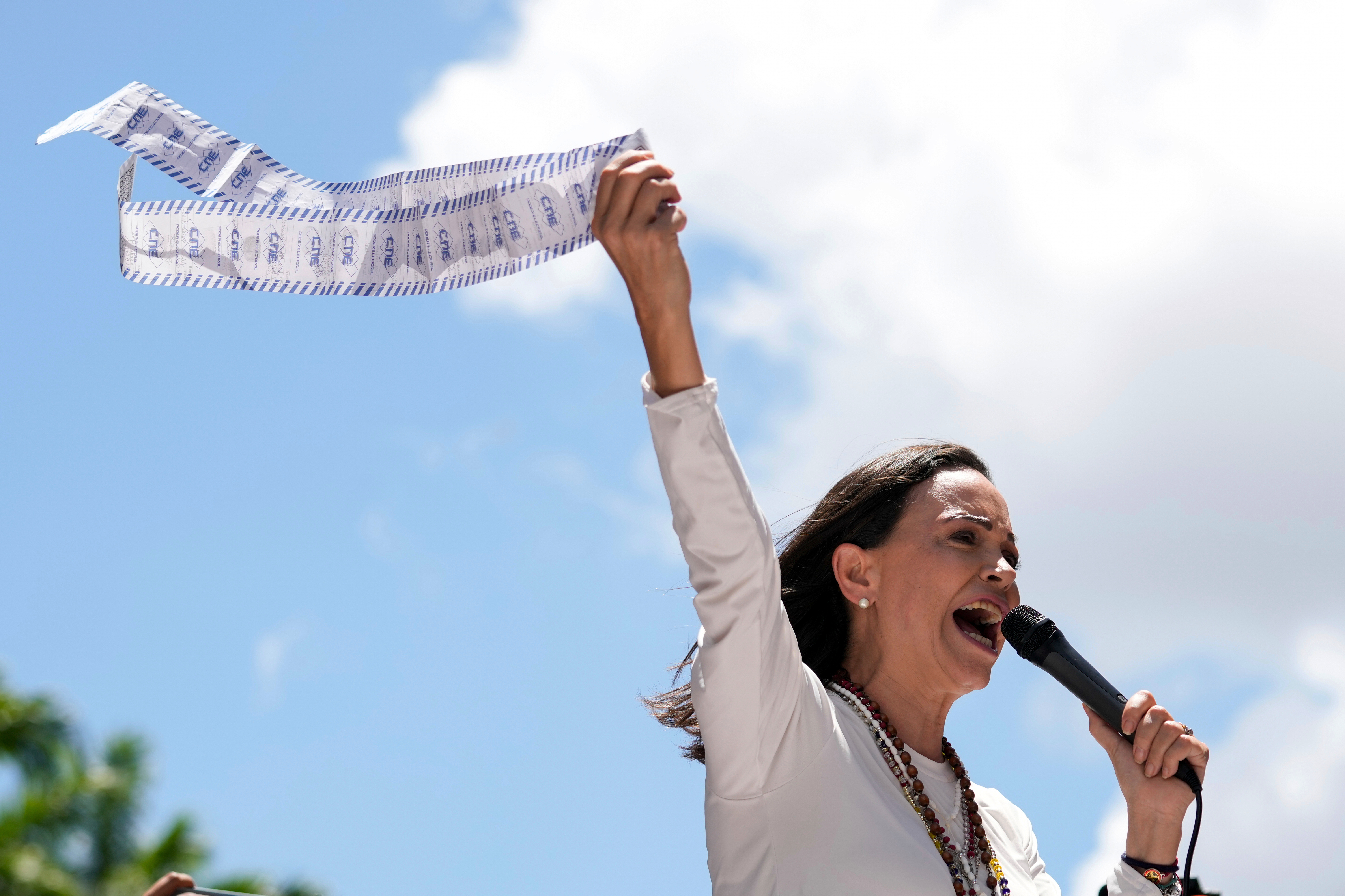 FILE - Opposition leader Maria Corina Machado displays vote tally sheets during a protest against the reelection of President Nicolas Maduro one month after the disputed presidential vote which she says the opposition won by a landslide, in Caracas, Venezuela, Wednesday, Aug. 28, 2024. (AP Photo/Ariana Cubillos, file)