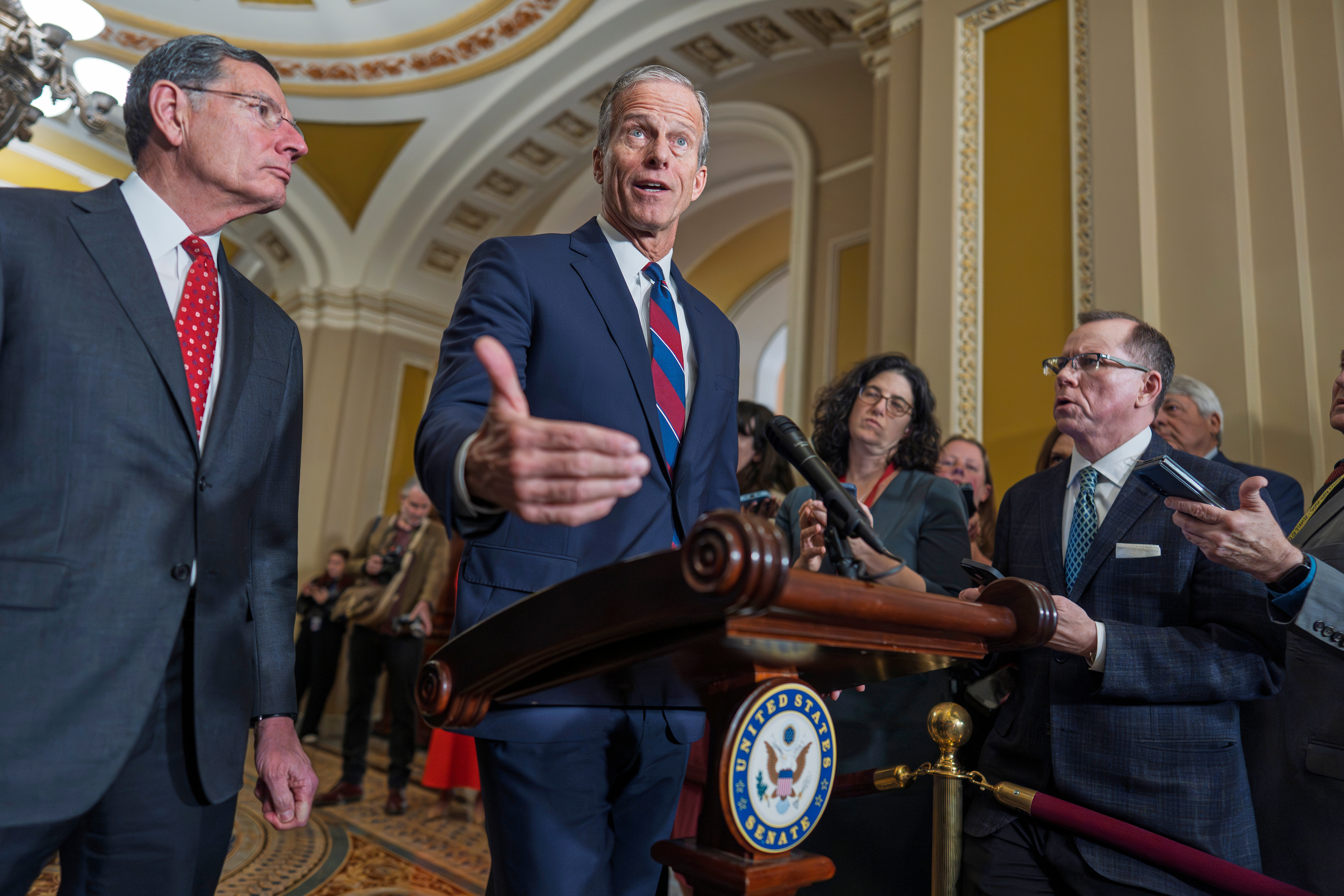 Senate Majority Leader John Thune, R-S.D., joined at left by Sen. John Barrasso, R-Wyo., speaks to reporters after a closed-door meeting with fellow Republicans, at the Capitol in Washington, Tuesday, Dec. 9, 2025. (AP Photo/J. Scott Applewhite)