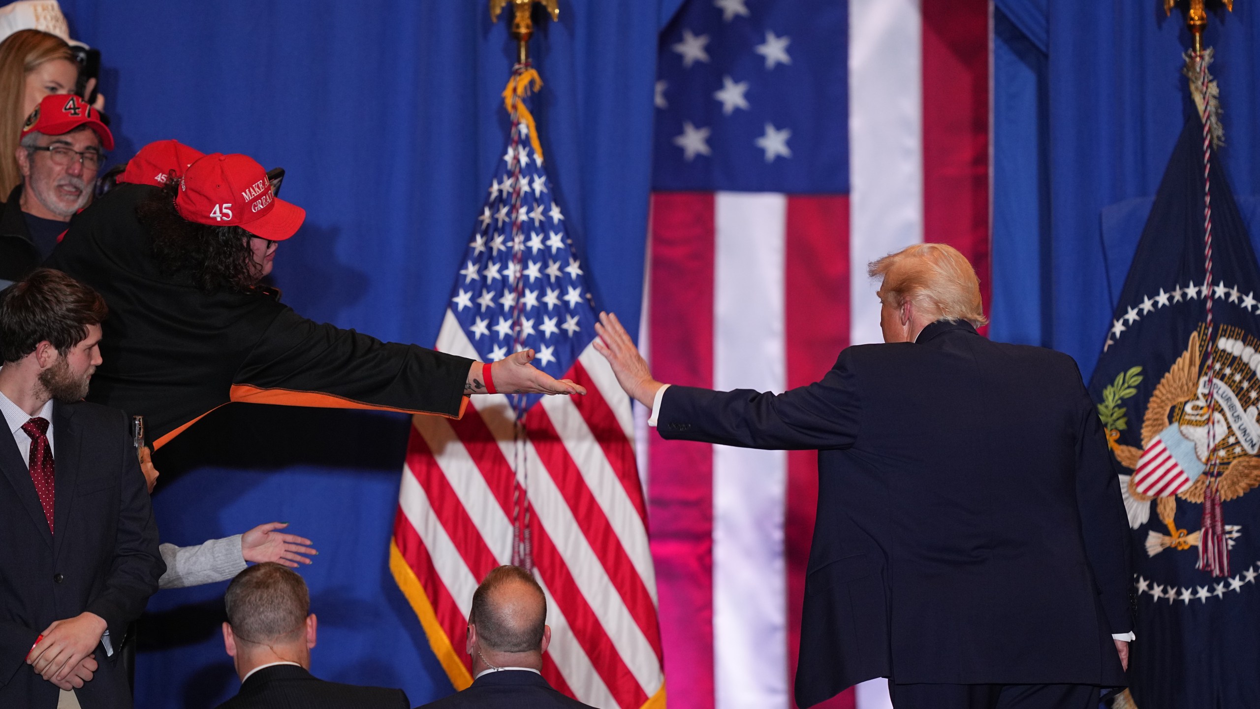 President Donald Trump reaches out to a supporter after speaking at the Mount Airy Casino Resort in Mount Pocono, Pa., Tuesday, Dec. 9, 2025. (AP Photo/Matt Rourke)