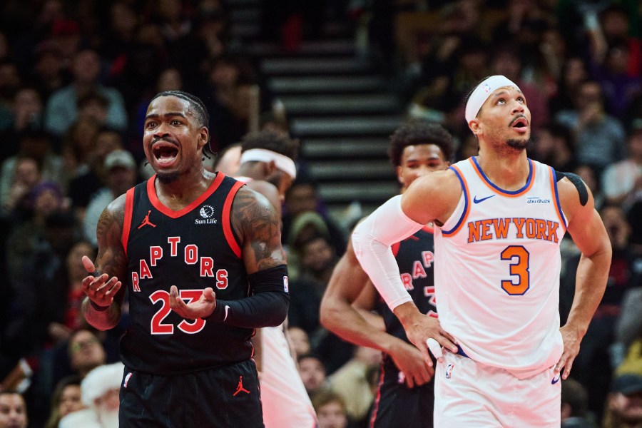 Toronto Raptors' Jamal Shead, left, and New York Knicks' Josh Hart (3) react to a call during the first half of an NBA Cup basketball game in Toronto, Tuesday, Dec. 9, 2025. (Sammy Kogan/The Canadian Press via AP)