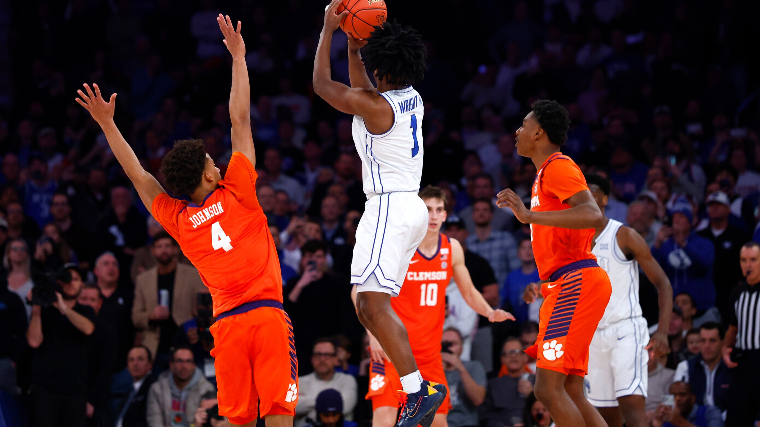 BYU guard Robert Wright III (1) makes the game winning shot against Clemson guard Efrem Johnson (4) during the second half of an NCAA basketball game, Tuesday, Dec. 9, 2025, in New York. (AP Photo/Noah K. Murray)