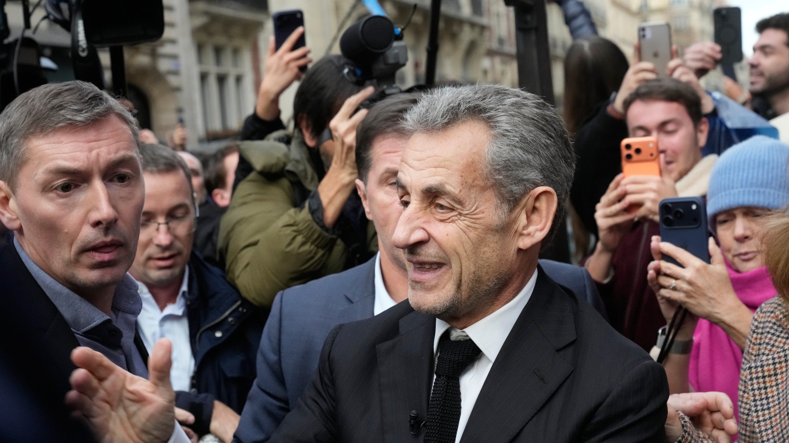 Former French President Nicolas Sarkozy arrives to sign his book "Diary of a Prisoner," in a Paris bookshop, Wednesday, Dec. 10, 2025. (AP Photo/Michel Euler)