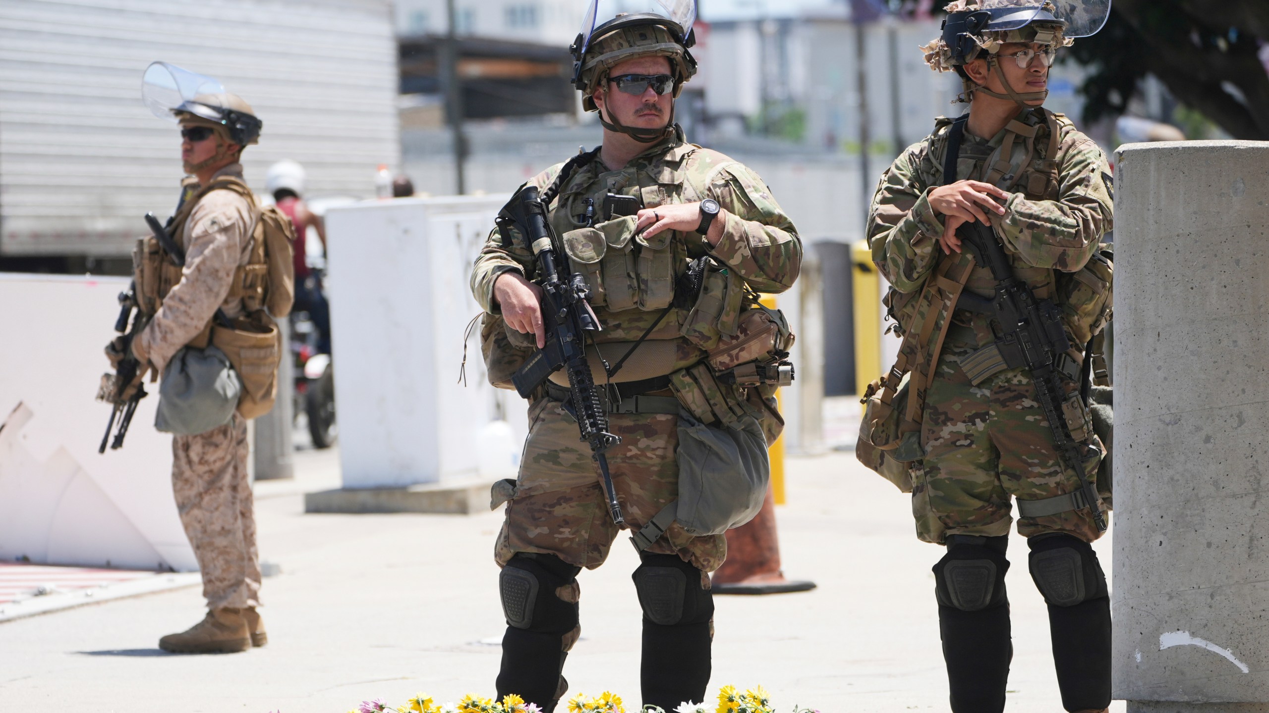 FILE - Members of the California National Guard and U.S. Marines guard a federal building on Tuesday, June 17, 2025, in Los Angeles. (AP Photo/Damian Dovarganes, File)