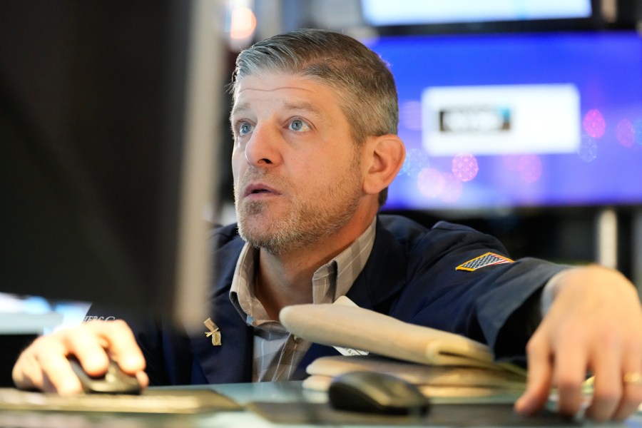 Michael Gallucci works on the floor at the New York Stock Exchange in New York, Wednesday, Dec. 10, 2025. (AP Photo/Seth Wenig)