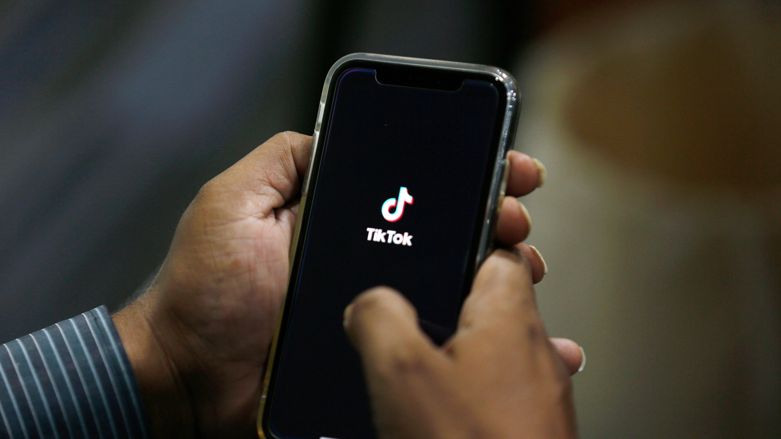FILE - In this July 21, 2020 file photo, a man opens social media app 'TikTok' on his cell phone, in Islamabad, Pakistan. (AP Photo/Anjum Naveed, File)